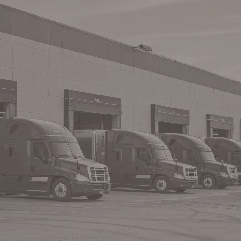 Semi trucks parked outside a loading station